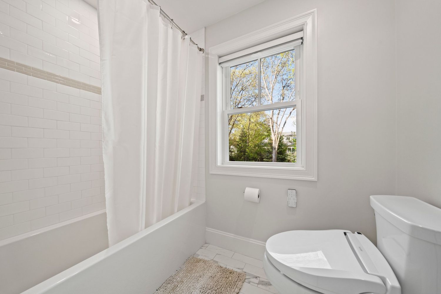 a living room with furniture a wooden floor and next to a window