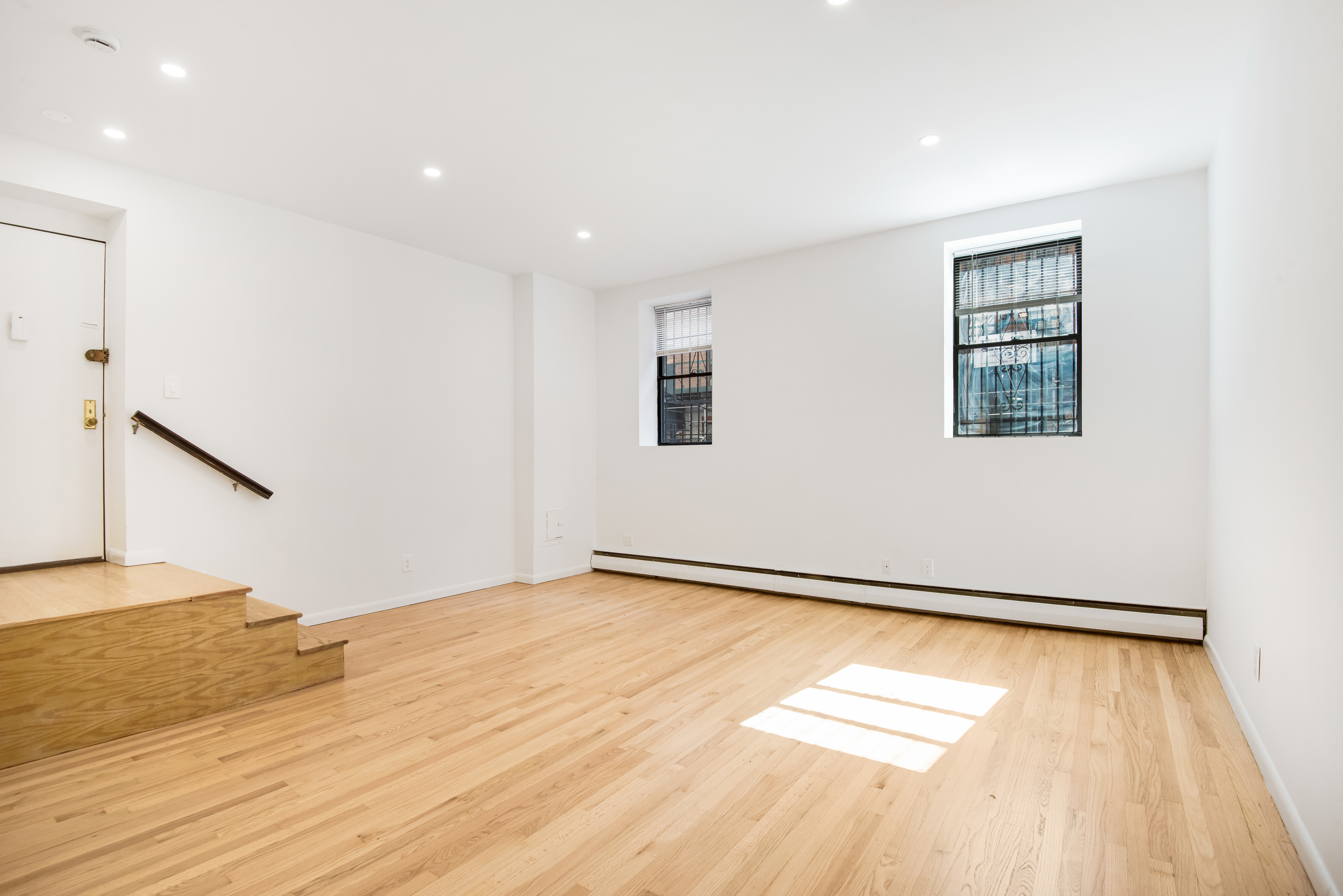 182 East 2nd Street, Unit 1E Manhattan, NY 10009 - Photo 2 of 14 a view of an empty room with wooden floor and a window