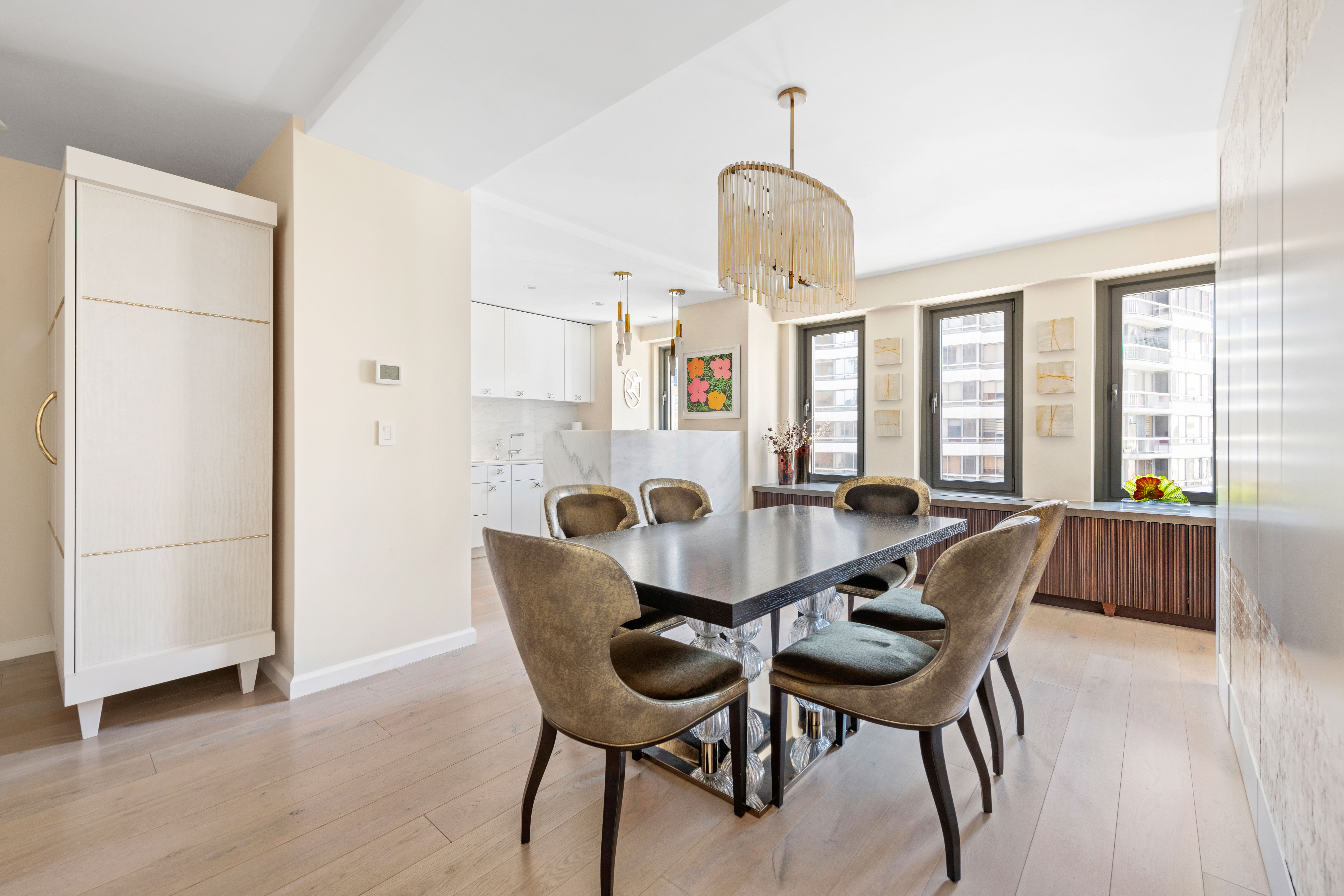 200 East 62nd Street, Unit 5A Manhattan, NY 10065 - Photo 6 of 25 a view of a dining room with furniture and a chandelier