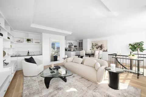 a living room with furniture white walls and white walls