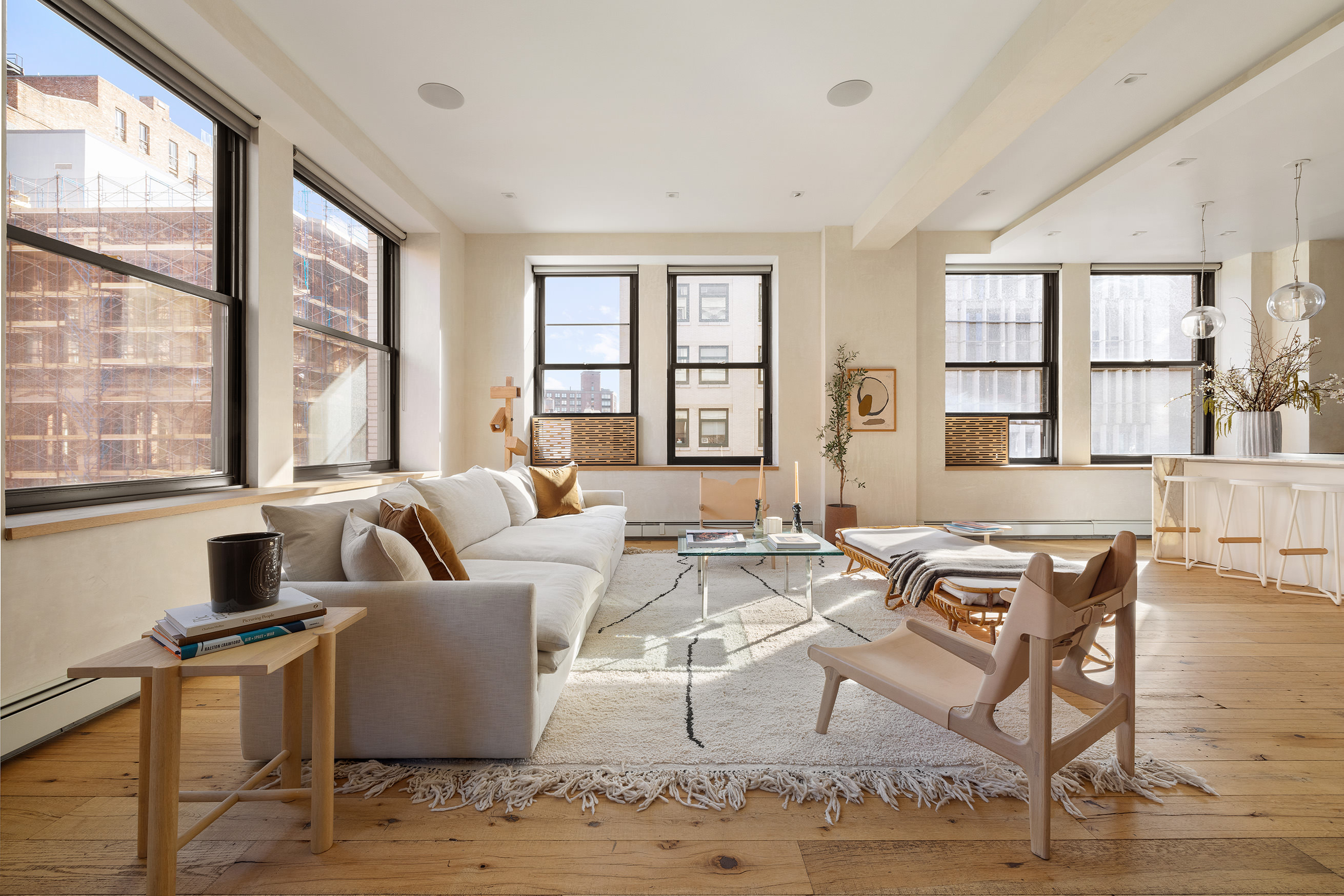 250 Mercer Street, Unit B706B707 Manhattan, NY 10012 - Photo 2 of 25 a living room with couches a coffee table and four couches next to a window