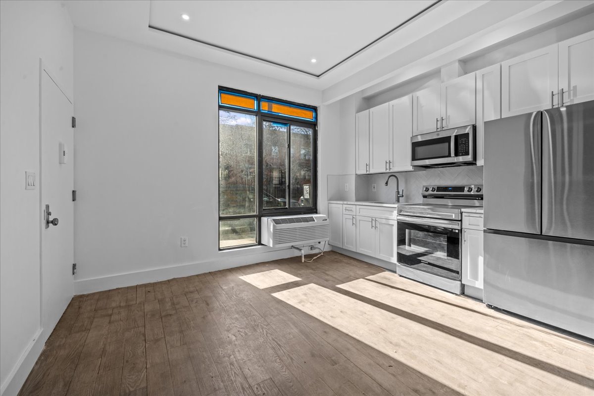 81 Suydam Street, Unit MULTI Brooklyn, NY 11221 - Photo 2 of 18 a kitchen with stainless steel appliances a stove and a refrigerator