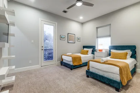 a bedroom with two beds and painting on the wall