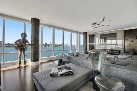 a living room with furniture and a floor to ceiling window