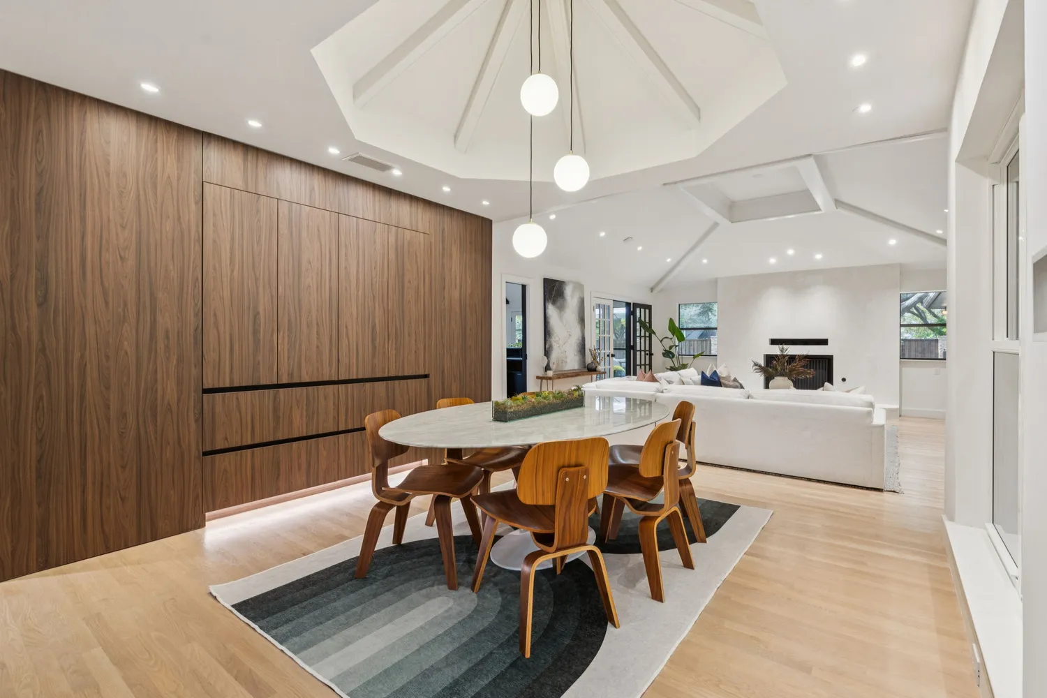 a living room with furniture and a floor to ceiling window