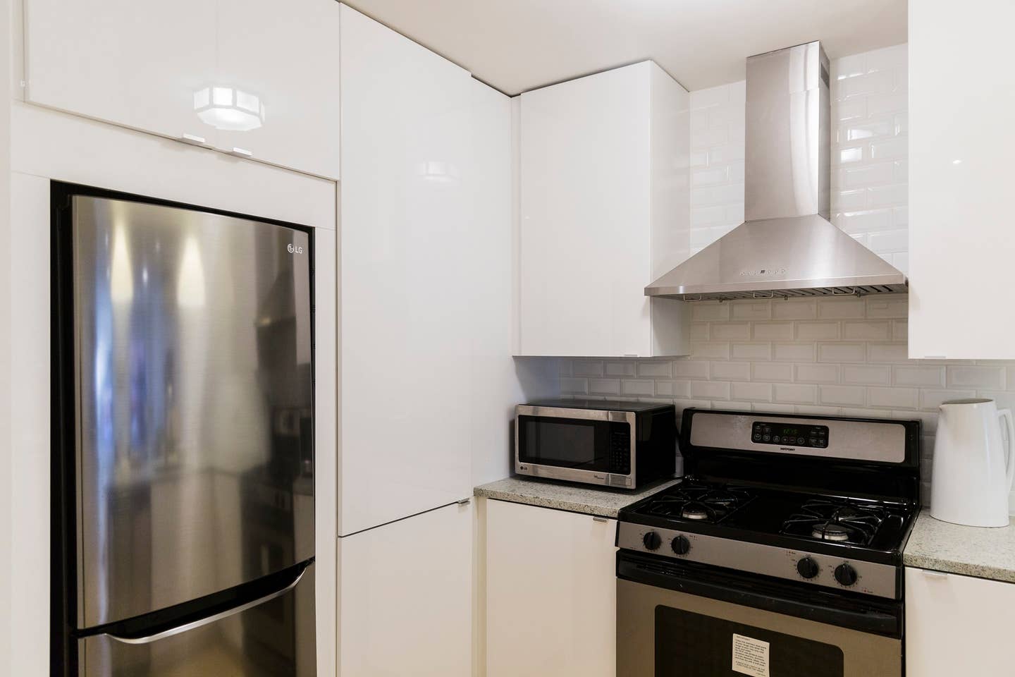 13 West 127th Street, Unit 1 Manhattan, NY 10027 - Photo 4 of 8 a kitchen with stainless steel appliances a refrigerator and a stove top oven