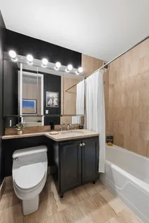 a bathroom with a sink a toilet and bathtub