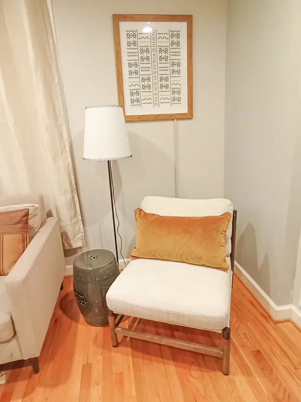 a bed sitting in a bedroom next to a window with exposed radiator
