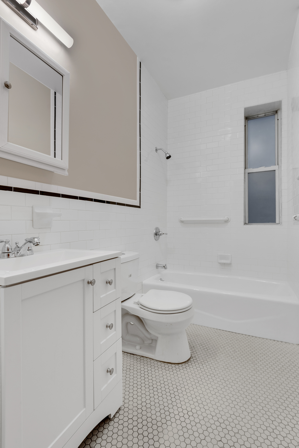 251 West 98th Street, Unit 1B Manhattan, NY 10025 - Photo 8 of 9 a bathroom with a toilet a sink a mirror and bathtub