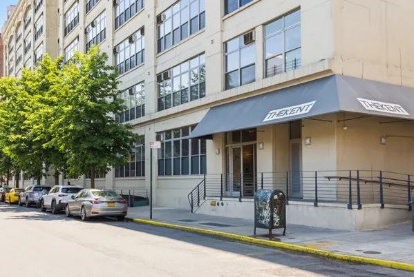 a view of a building with car parked