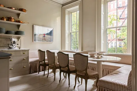 a view of a dining room with furniture and windows