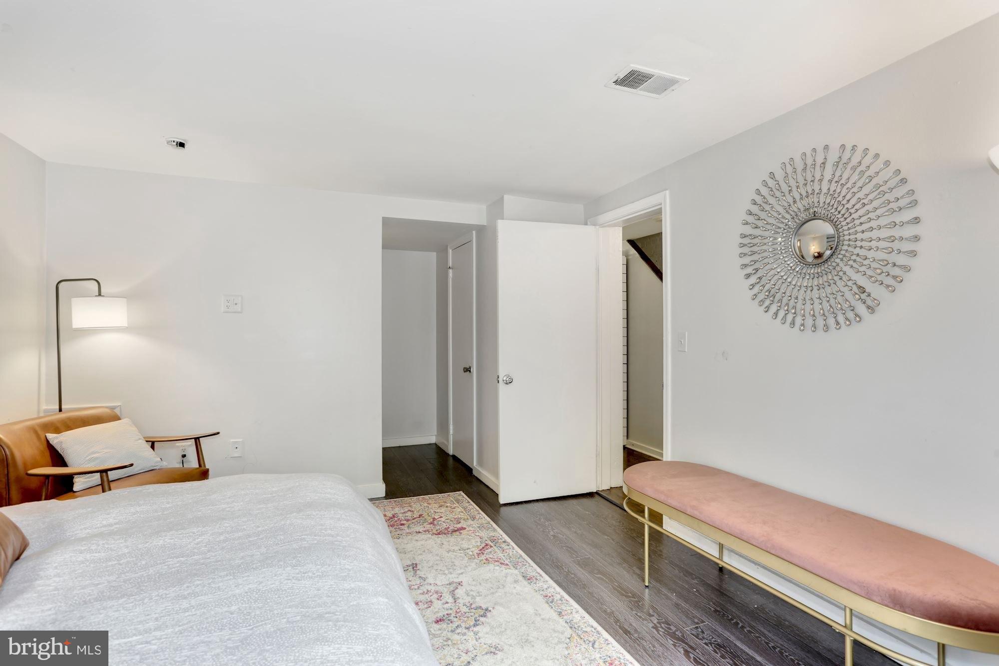 1317 Corcoran Street Northwest Washington, DC 20009 - Photo 47 of 47 a bedroom with a bed and a chandelier