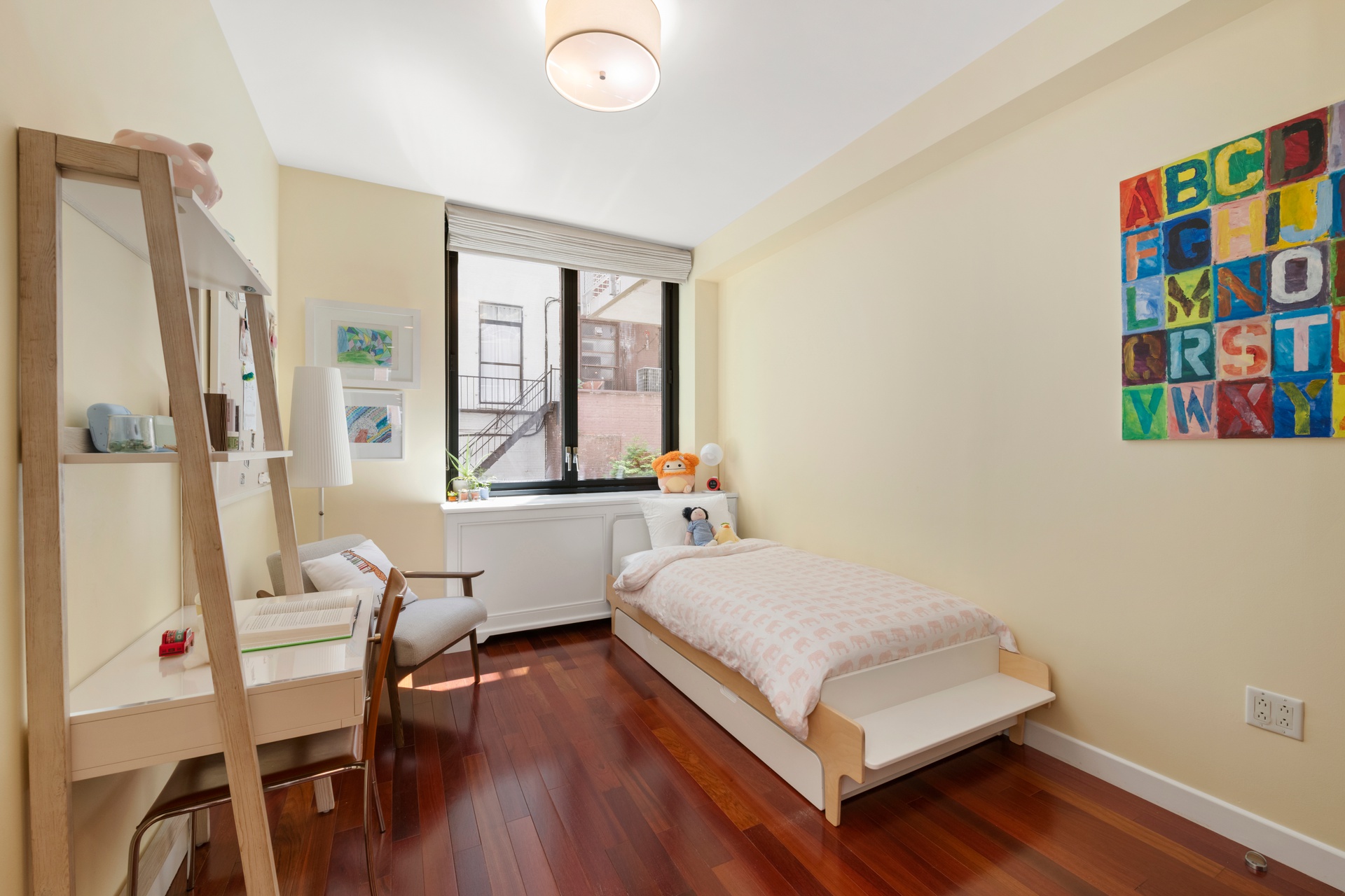 50 West 15th Street, Unit 2D Manhattan, NY 10011 - Photo 7 of 15 a bedroom with a bed and a book shelf