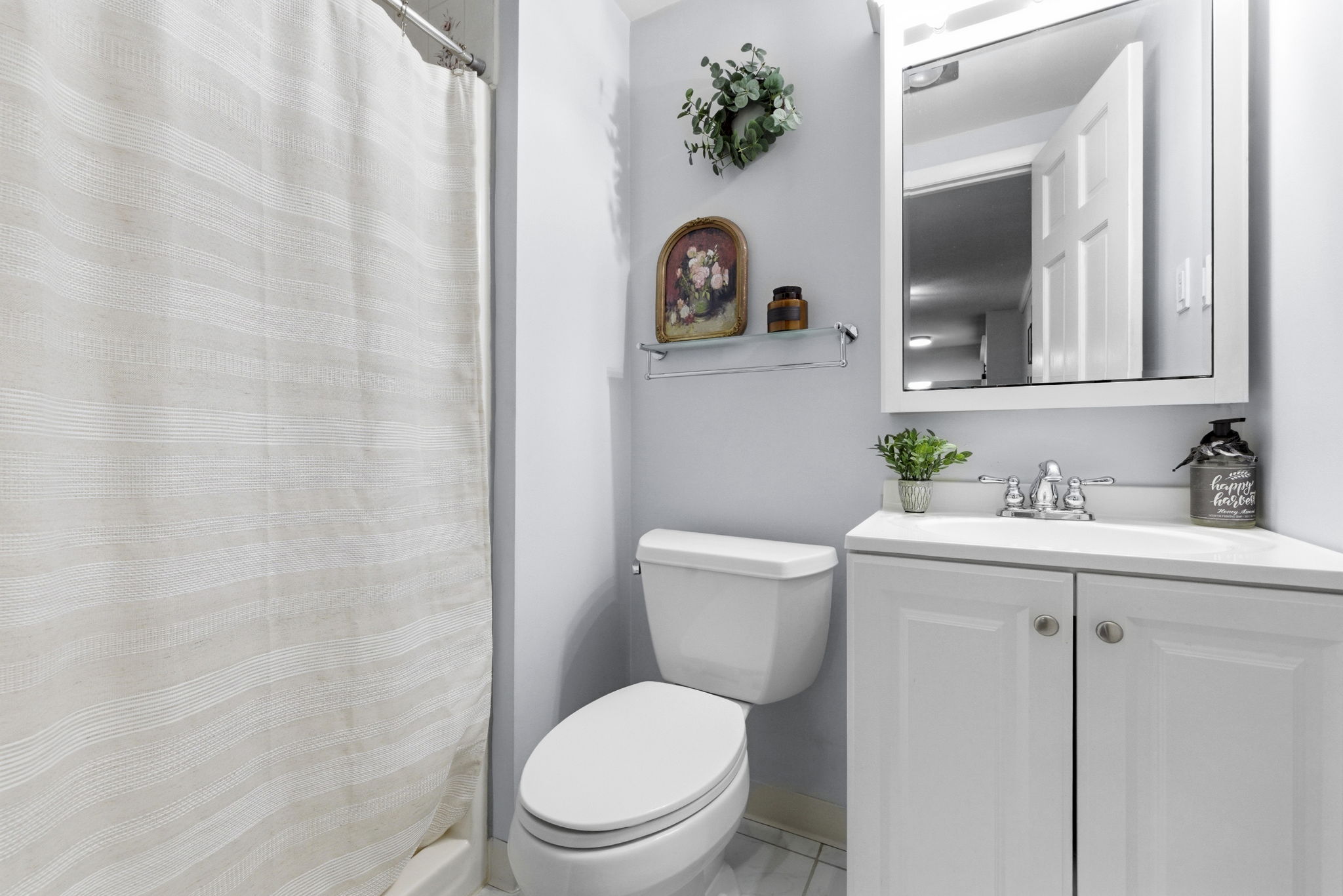 61 Wright Street, Unit 102 Stoneham, MA 02180 - Photo 11 of 26 a bathroom with a toilet sink and mirror