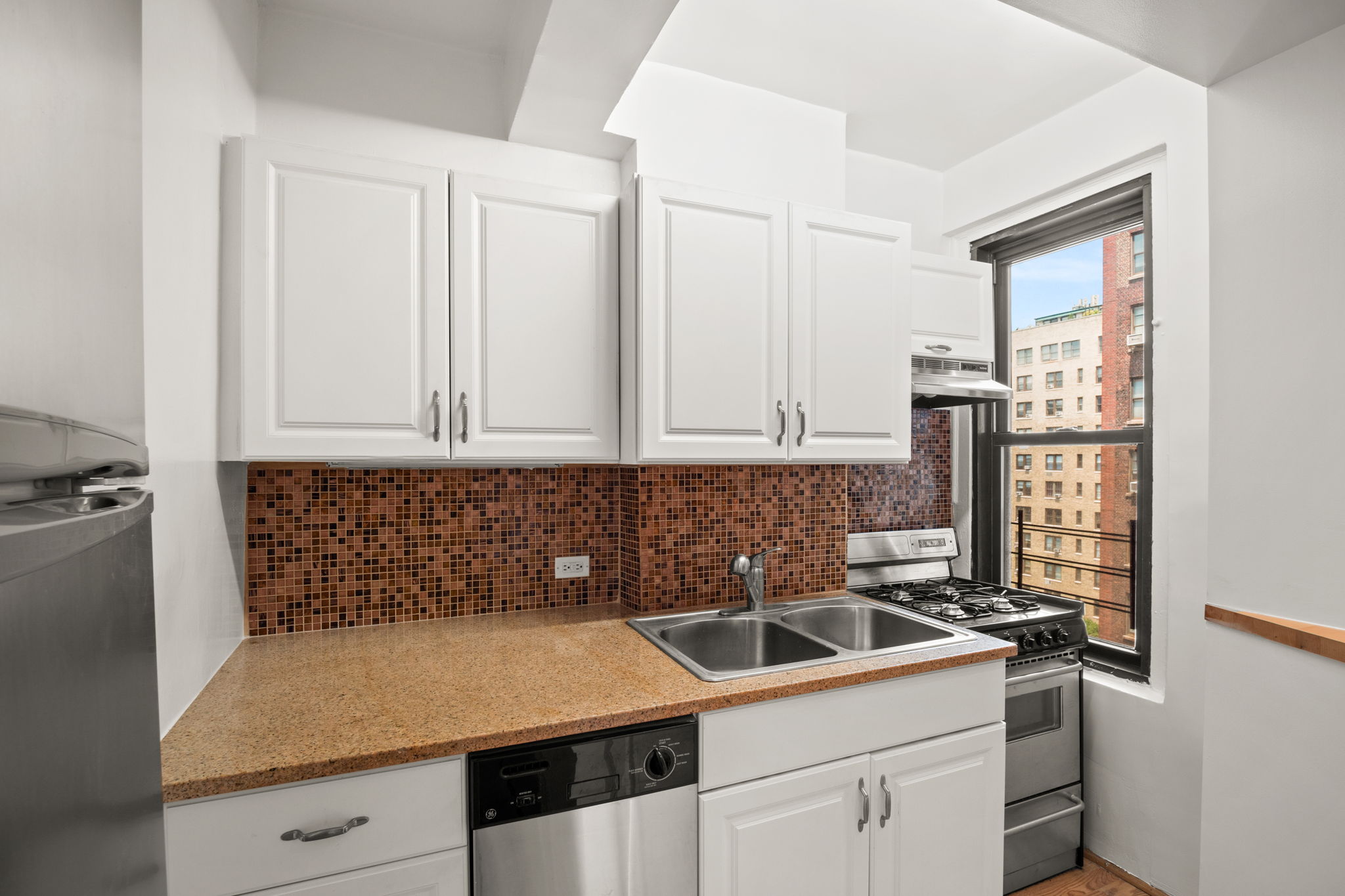 235 West End Avenue, Unit 12H Manhattan, NY 10023 - Photo 4 of 16 a kitchen with a sink and cabinets
