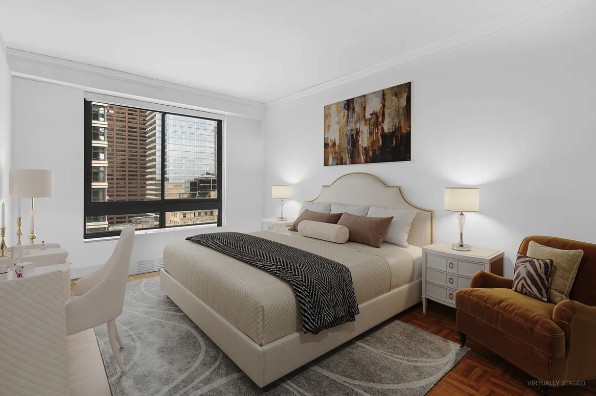 167 East 61st Street, Unit 21B Manhattan, NY 10065 - Photo 6 of 12 a bedroom with a bed couch and a large window