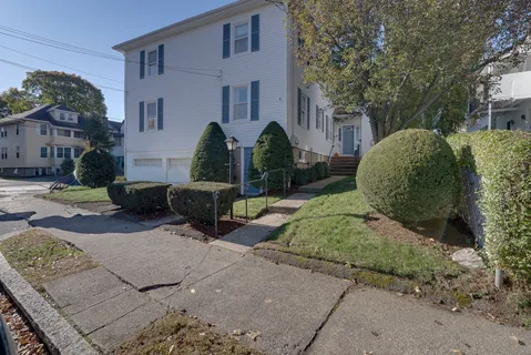 a view of a bench in front of house