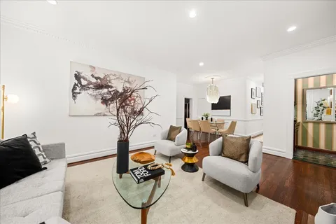 a living room with furniture and kitchen view