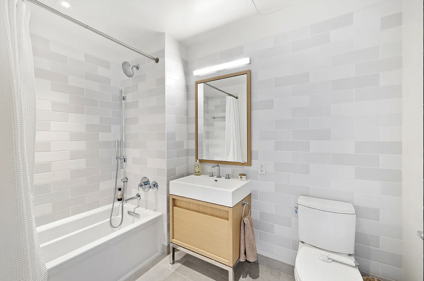 550 Vanderbilt Avenue, Unit 525 Brooklyn, NY 11238 - Photo 4 of 6 a bathroom with a sink a toilet and shower