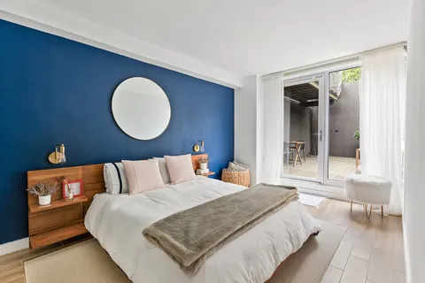 a bedroom with bed and a large window