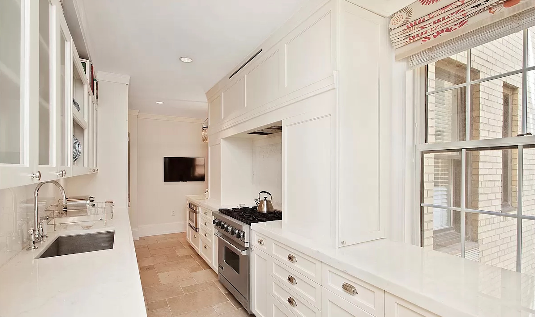 40 East 66th Street, Unit 8C Manhattan, NY 10065 - Photo 3 of 16 a spacious bathroom with a double vanity sink a mirror a bathtub and next to a window