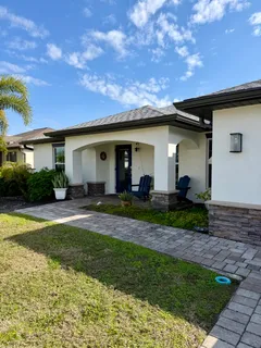 a front view of house with a garden