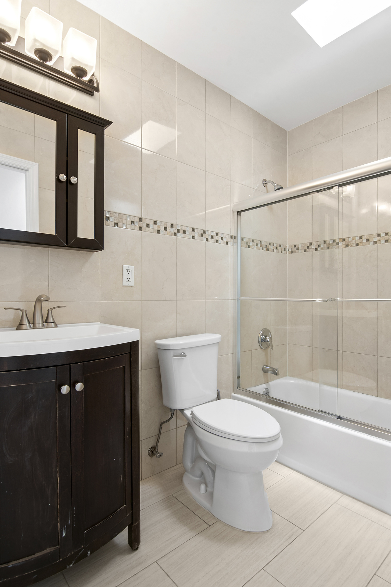 41-05 20th Avenue Queens, NY 11105 - Photo 16 of 20 a bathroom with a sink a toilet and shower