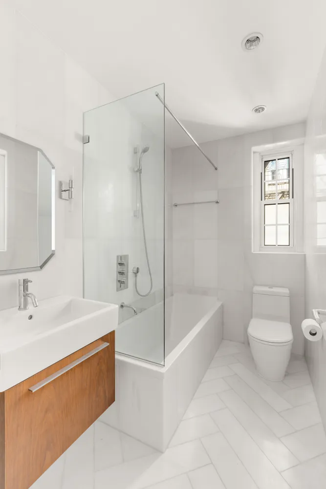 a bathroom with a sink a toilet and bathtub