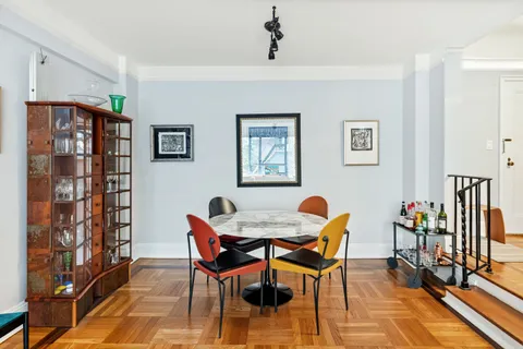 a dining room with furniture and wooden floor