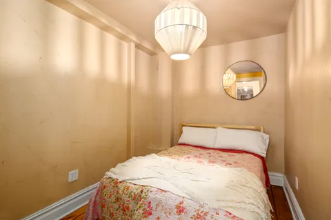 a bedroom with a bed and a mirror