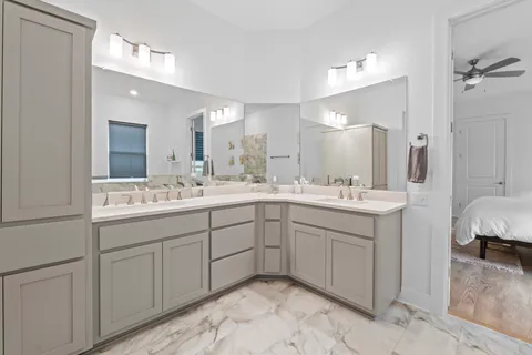 a spacious bathroom with a double vanity sink double and mirror