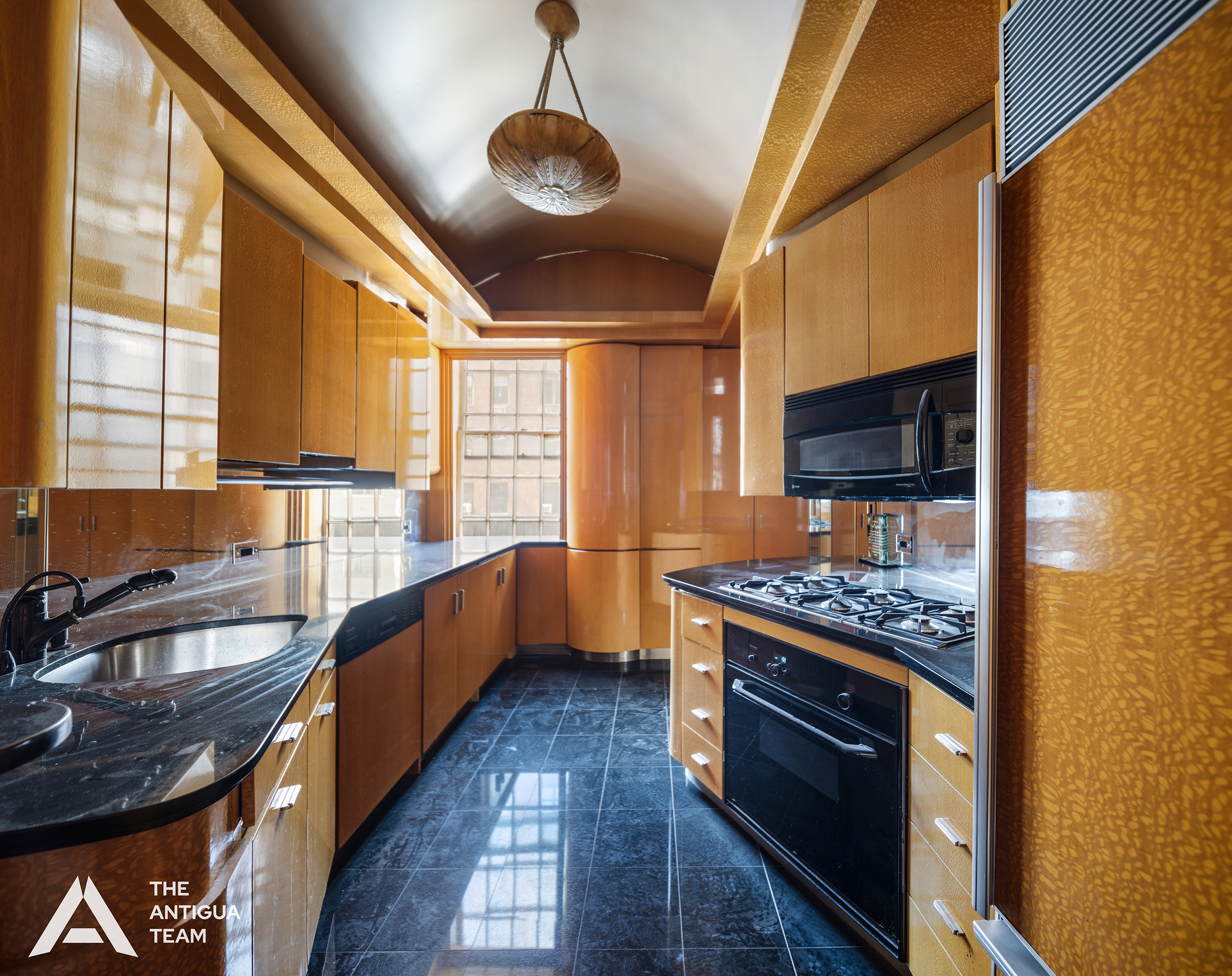 45 East 66th Street, Unit 4W Manhattan, NY 10065 - Photo 20 of 27 a kitchen with stainless steel appliances granite countertop a stove and a sink