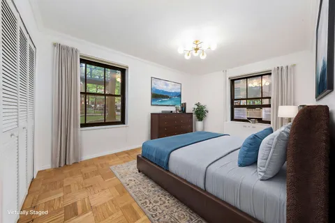 a bedroom with a large bed and a window