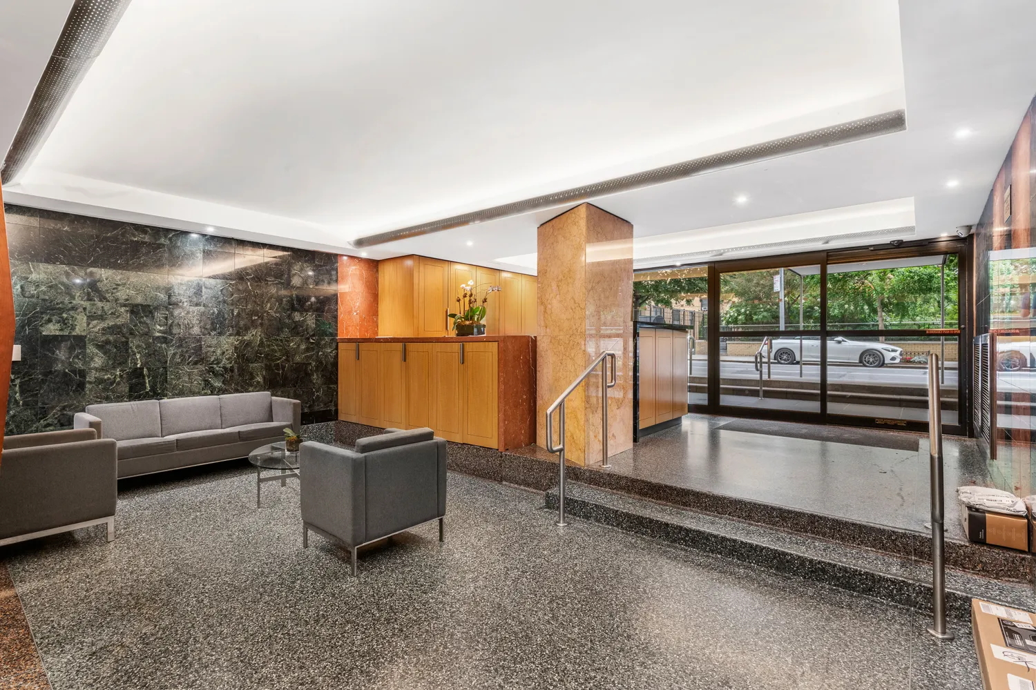 a living room with couch and a floor to ceiling window