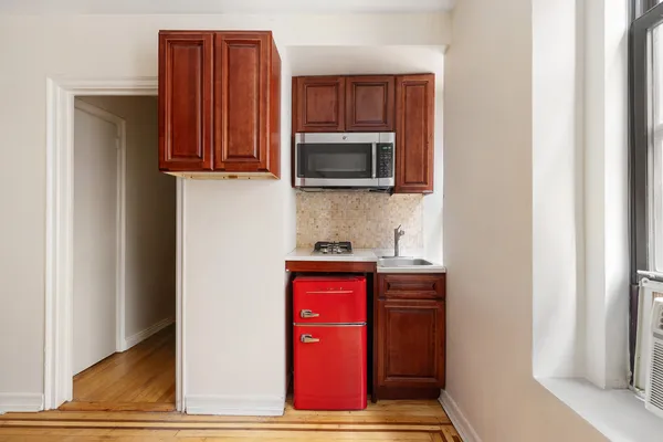 a kitchen with stainless steel appliances granite countertop a refrigerator and microwave
