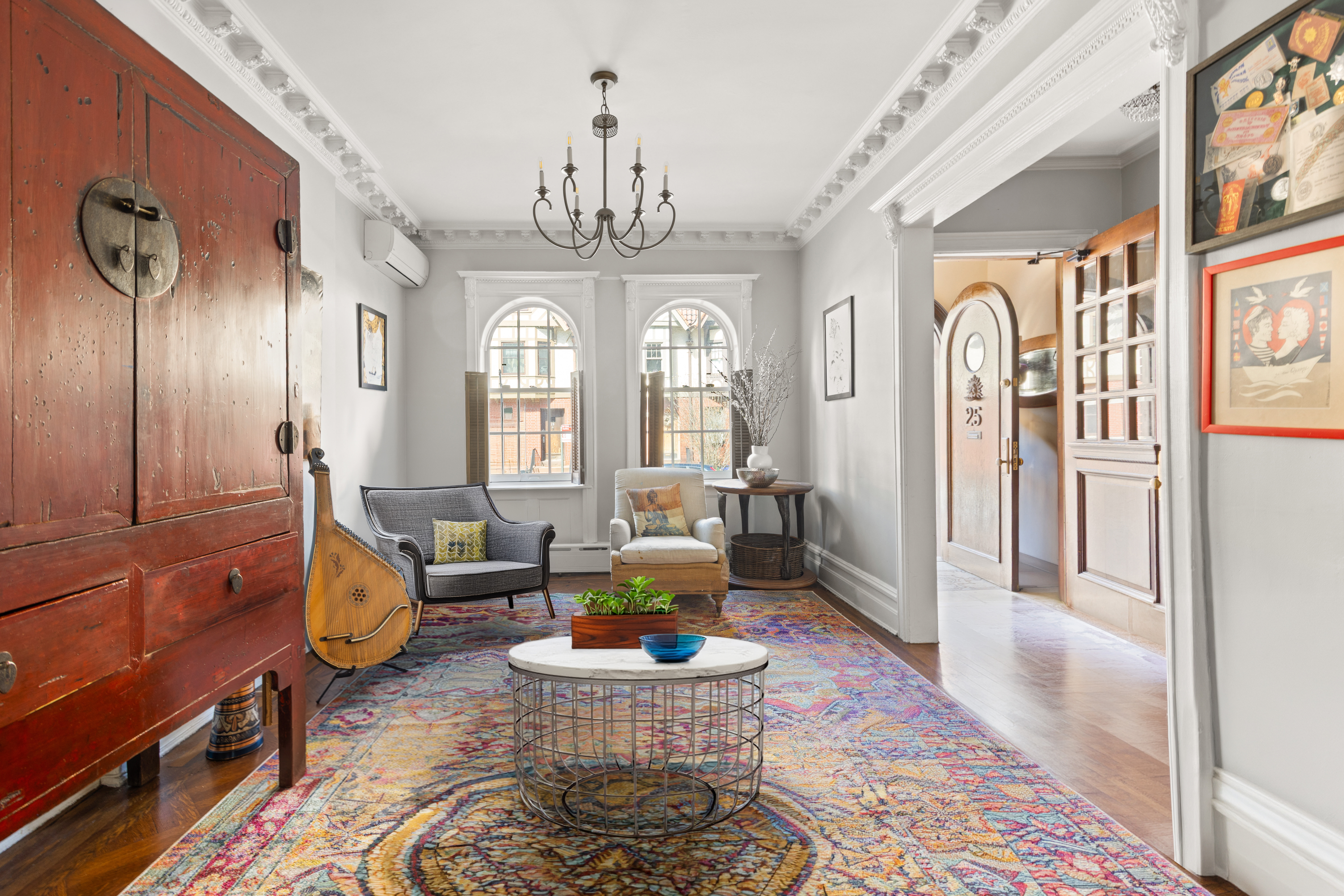 25 Chester Court Brooklyn, NY 11225 - Photo 3 of 17 a living room with furniture chandelier and a rug
