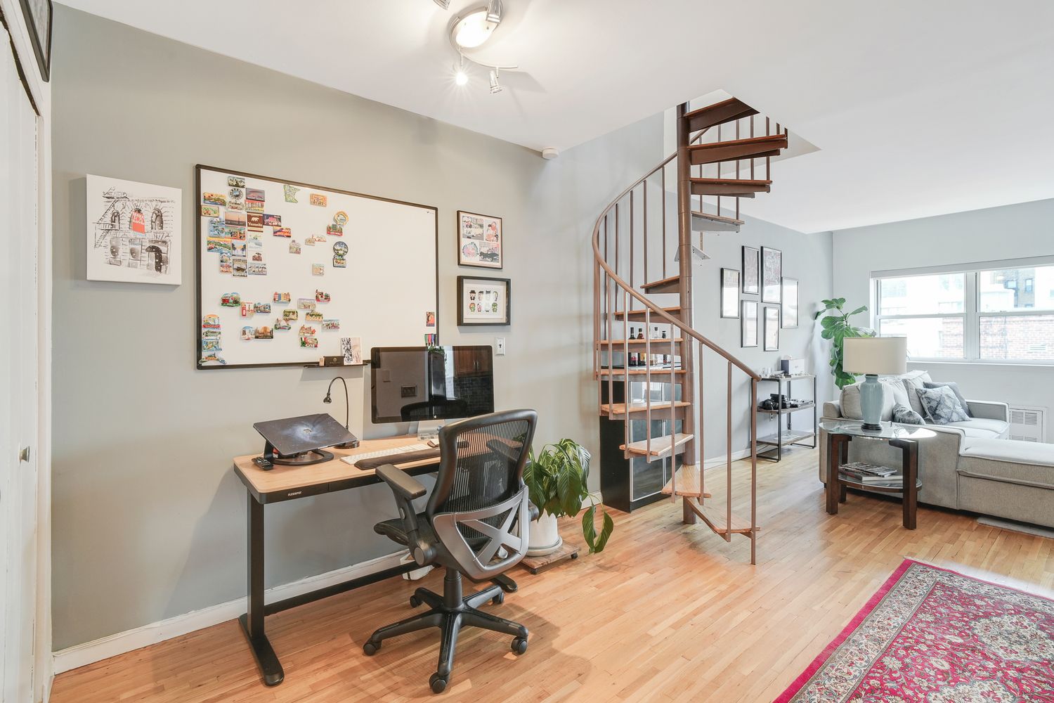 a workspace with wooden floor and a rug