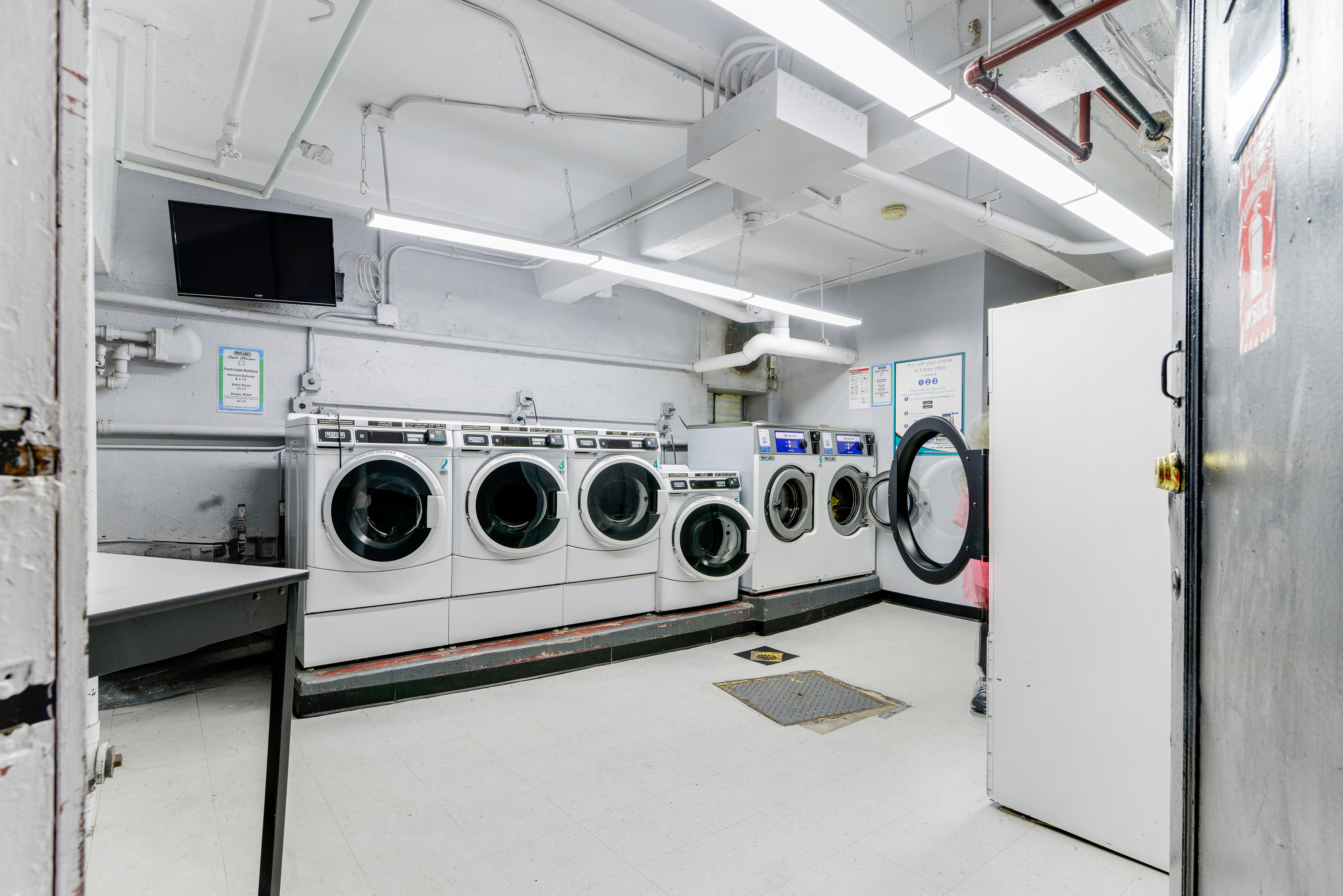 5614 Netherland Avenue, Unit 4E Bronx, NY 10471 - Photo 7 of 8 a utility room with dryer and washer