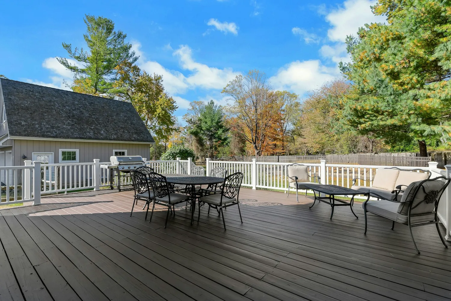 a view of a deck with table and chairs and wooden floor