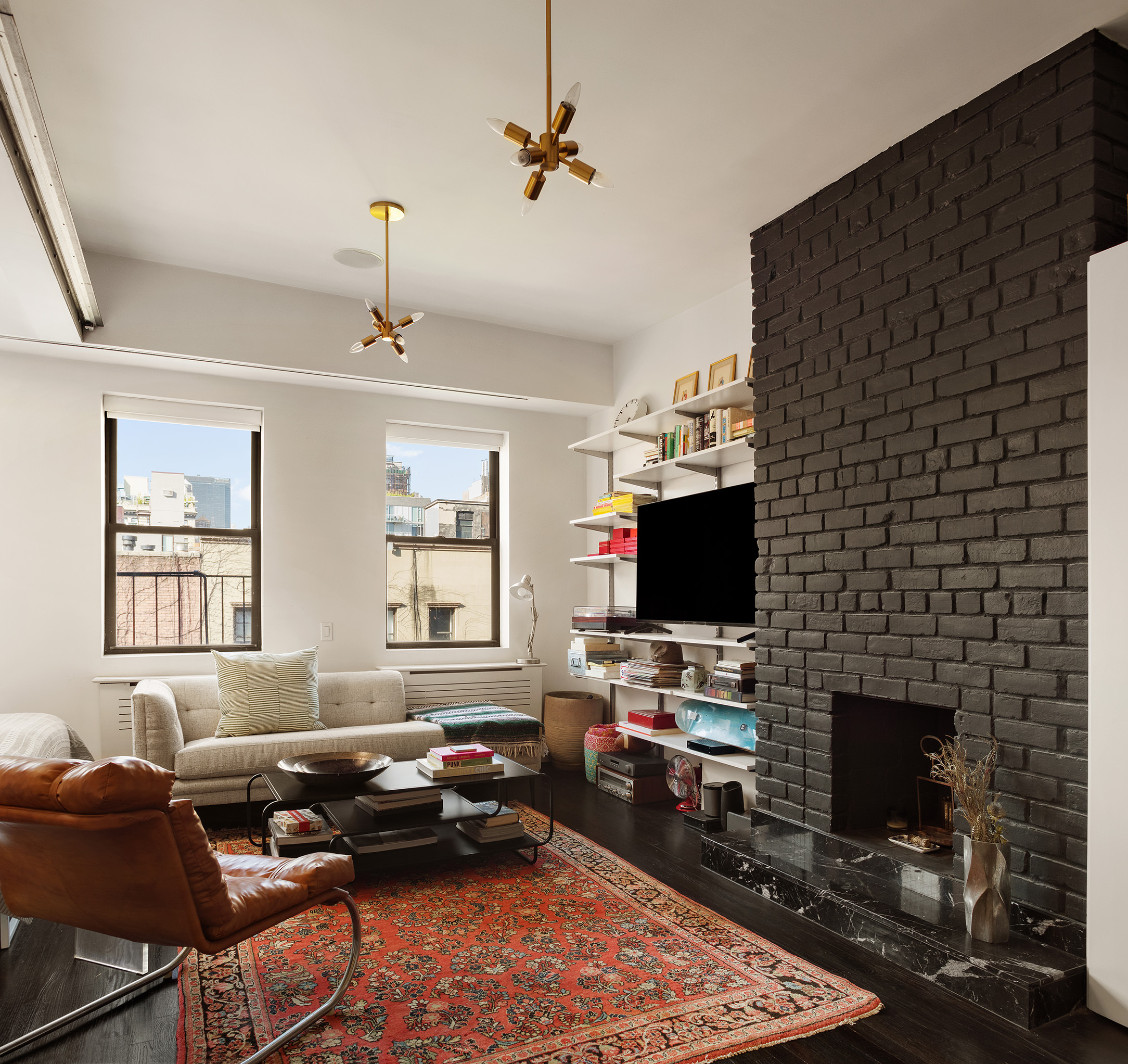 a living room with furniture a fireplace and a flat screen tv