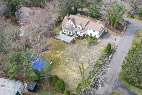 an aerial view of a house with a yard