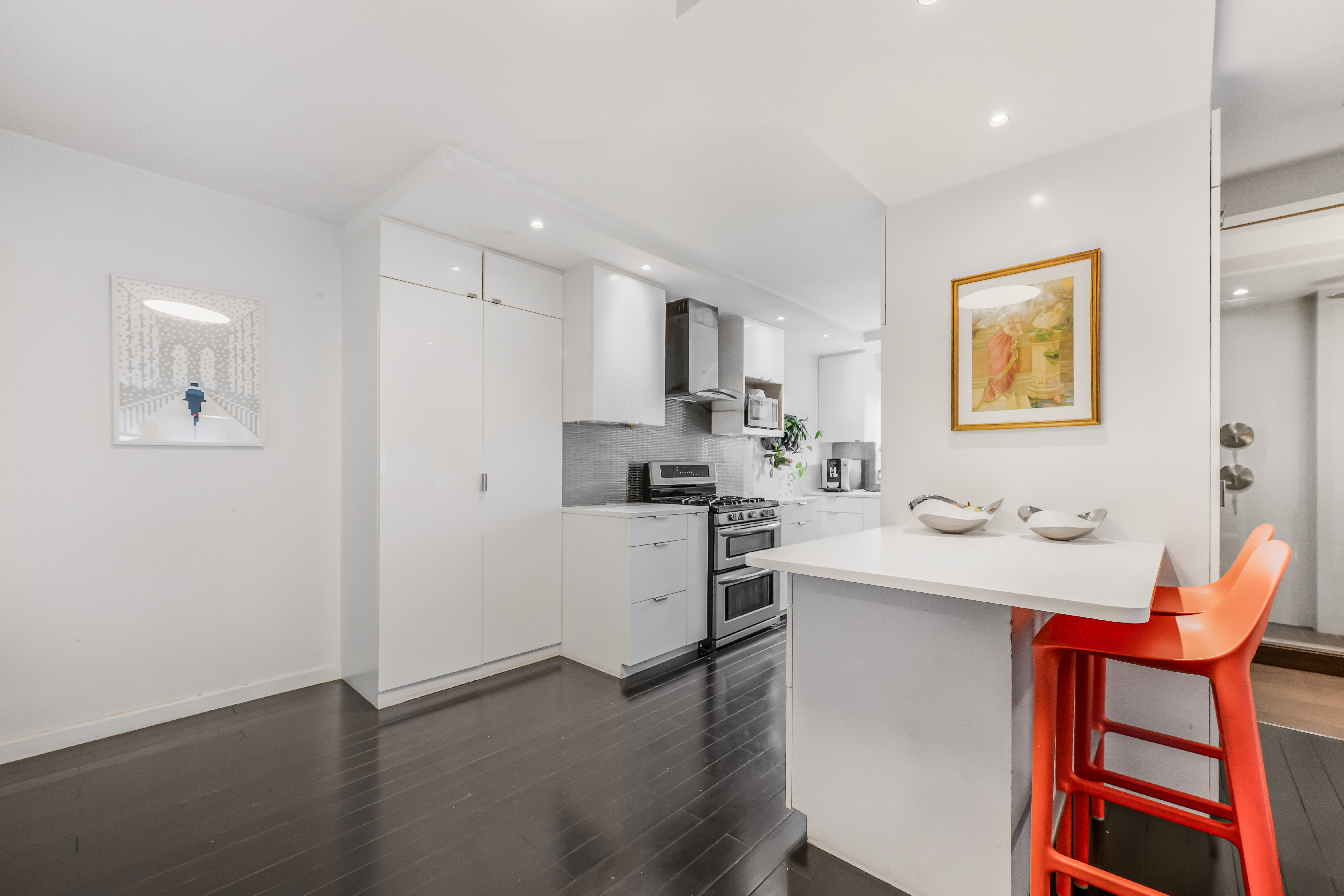 520 East 76th Street, Unit 10H Manhattan, NY 10021 - Photo 3 of 20 a kitchen with stainless steel appliances kitchen island granite countertop a sink and cabinets