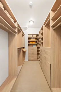 a view of walk in closet with empty racks