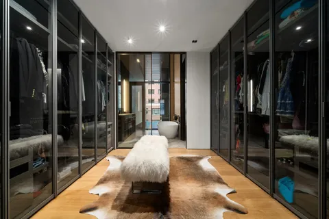 a large bedroom with a large bed and a glass door shower