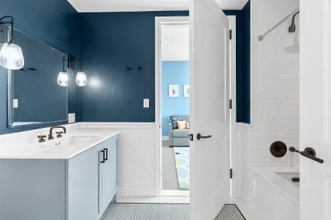 a bathroom with a sink a mirror and shower