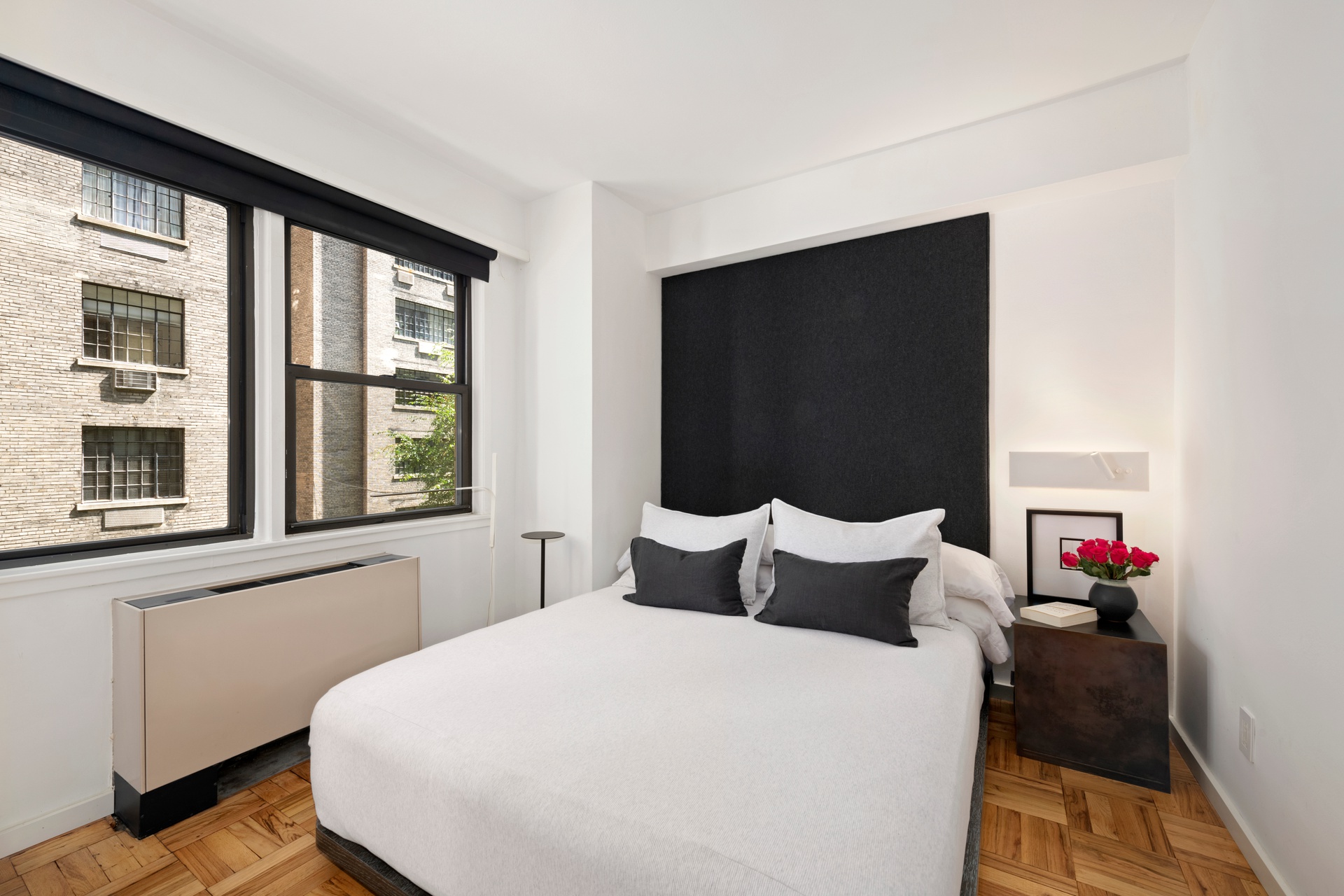 55 East 9th Street, Unit 4N Manhattan, NY 10003 - Photo 6 of 10 a bedroom with a bed and a large window