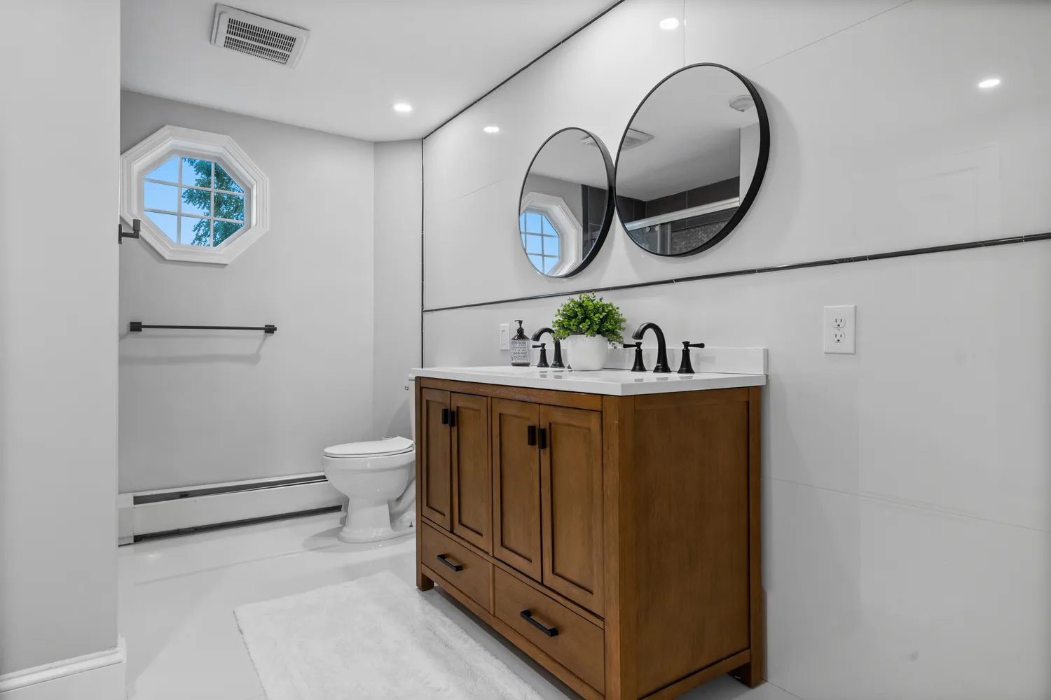 a bathroom with a sink a mirror and toilet