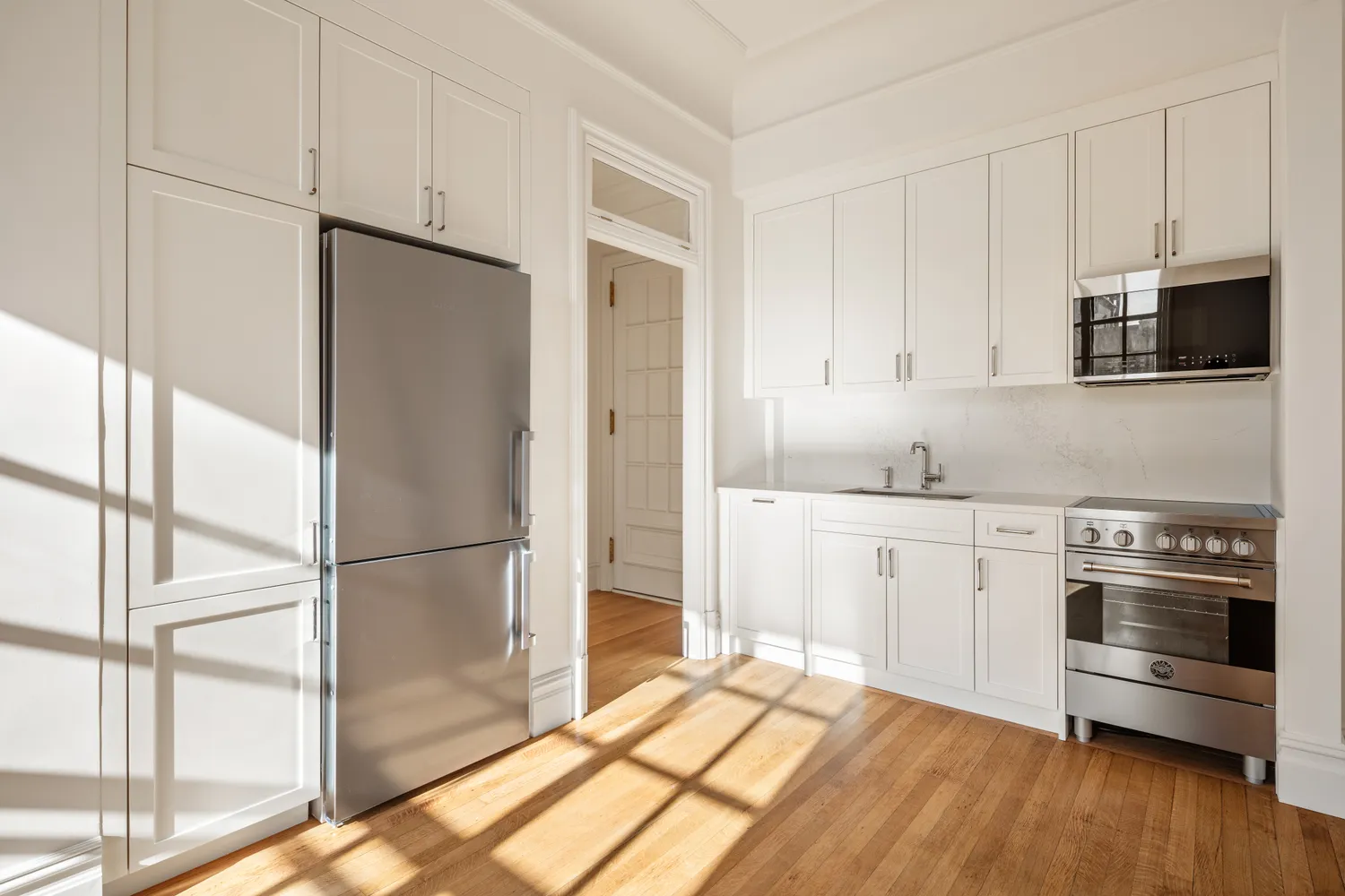 a kitchen with stainless steel appliances granite countertop a refrigerator and a stove top oven