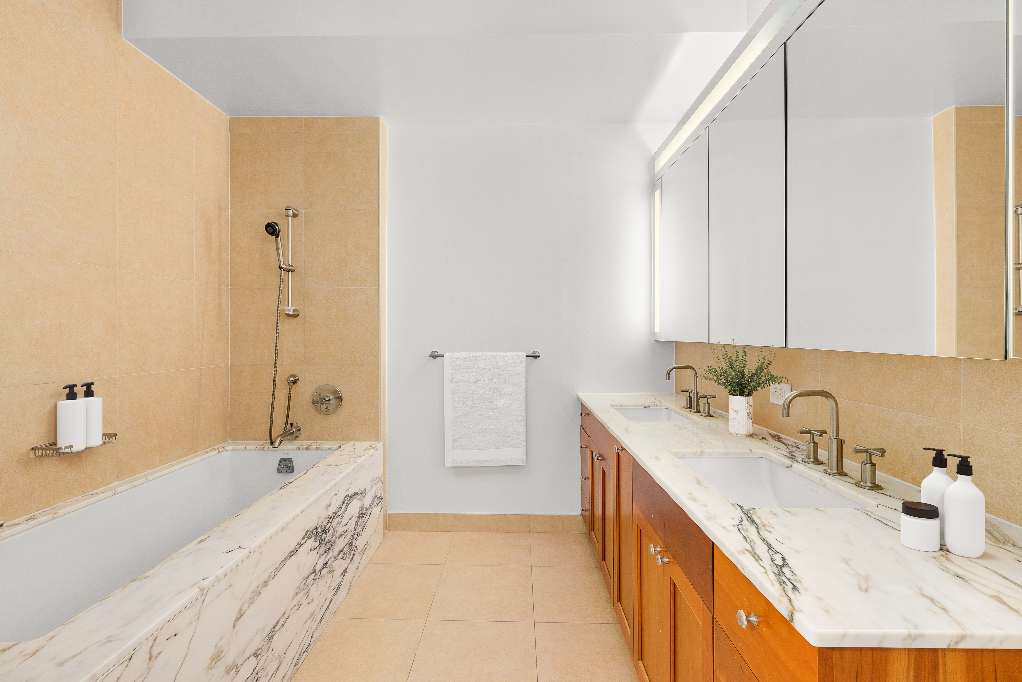 9 College Place, Unit 3K Brooklyn, NY 11201 - Photo 4 of 7 a bathroom with a granite countertop tub sink and mirror