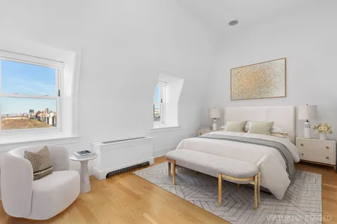 a bedroom with a bed and a couch